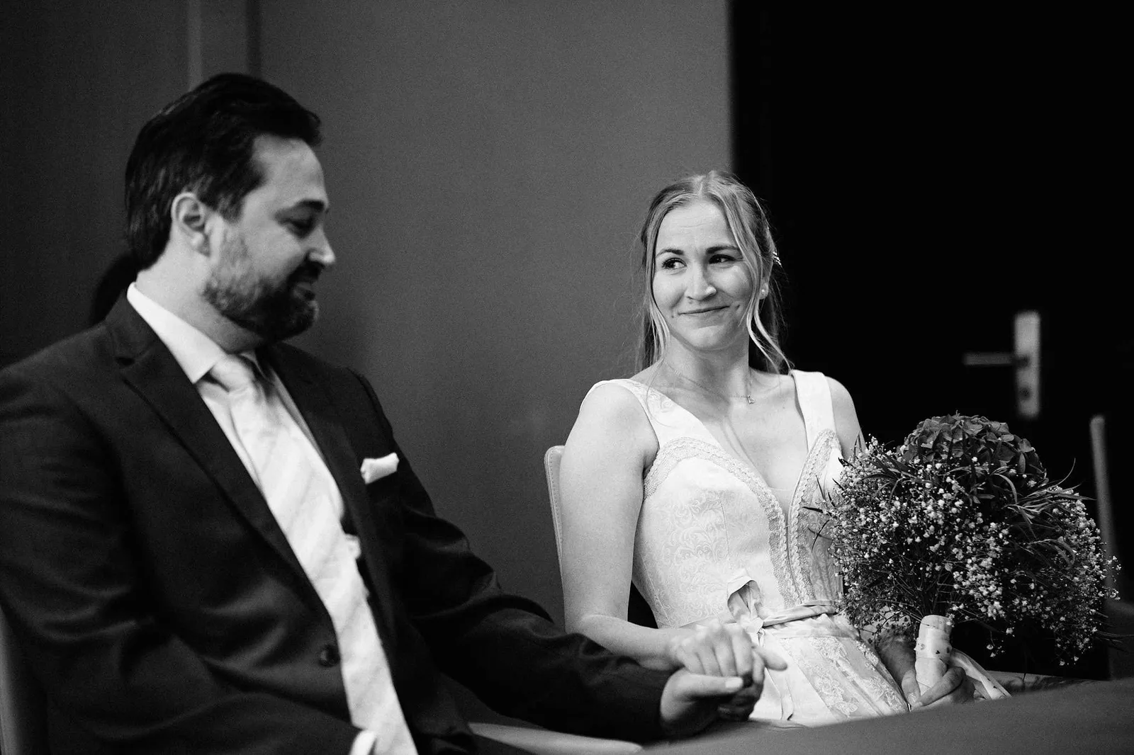 Brautpaar sitzt lächelnd im Trauzimmer, Schwarzweißaufnahme – Hochzeit Katharina & Christian, Schaezlerpalais
